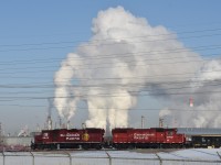 Blowing off steam....Vapour clouds rising from Imperial Oil's Strathcona Refinery give the impression that these two units have one heck of a cooling system problem. This is what happens when CN sends you to Edmonton in March. 