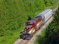 With a lone car for PDI Elizabeth in tow, OSR's 1400 job approaches Guelph at a place once known as Speedwell.  Located at mile 29.6 on the <a href=https://open.library.ubc.ca/collections/chung/chungtext/items/1.0362209#p7z-3r0f:>Goderich sub (page 9),</a> Speedwell was a flag stop for the CPR, the Toronto Suburban Railway, and the Guelph Radial Railway; the latter two being electric lines.<br><br>Built under the direction of Sir William Mackenzie and Sir Donald Mann (of Canadian Northern Railway fame), the Toronto Suburban Railway's Guelph Line ran 49.4 miles from Toronto at St. Clair and Keele Street through towns including Cooksville, Meadowvale, Georgetown, Eden Mills, and Guelph.  There was 100 stops along the line, many likely at farmers' crossings lacking any formal station.  Mackenzie & Mann's aim of building quality lines at low cost saw the line built with 60lb rails, weaving west through many curves and over large bridges including the 711-foot long <a href=http://www.trainweb.org/oldtimetrains/TSR/humber-bridge_radial-car.jpg>Humber River bridge</a> and a <a href=http://www.trainweb.org/oldtimetrains/TSR/credit-trestle.jpg>315 foot wooden trestle</a> across the Credit River near Norval, until reaching the Guelph terminus at the <a href=https://s3.amazonaws.com/pastperfectonline/images/museum_51/055/19861815.jpg>Grand Trunk Railway station</a> on Carden Street via a connection with the Guelph Radial Railway at Dundas Street and Bay Street; now renamed Gordon Street and James Street East.  A storefront on Carden Street <a href=https://s3.amazonaws.com/pastperfectonline/images/museum_51/113/2009323390.jpg>(behind train here)</a> across from GTR's station provided TSR customers with a place to purchase tickets.  Being a longer interurban line, the <a href=https://dynamicmedia.zuza.com/zz/m/original_/9/3/9321821e-7363-4ae2-8a5f-12903a1d5dd3/B88807107Z.1_20190802145153_000_G2MM0KT3.4-0_Super_Portrait.jpg>TSR cars</a> on the Guelph Line were larger, constructed by the Preston Car and Coach Co, described as a "68-seat affair and nicely appointed with cherry wood finish throughout, comfortable green, plush, upholstered, high-backed seats with headrests, footrests and polished bronze handles on the aisle sides."  The first car over the line arrived in Guelph on Thursday, August 12, 1917 with management and foreman aboard, declaring on arrival, that the line would open to the public that Saturday, August 14.  The intended destination of the Guelph Line after surveying during 1911 was originally Berlin, now Kitchener, however restrictions and costs during WWI resulted in the destination of Guelph.  Three hydro substations were built to supply the line with 1,500 volt D.C. but only 2 (Islington, Georgetown) were ever used.  The third, located in Guelph on <a href=https://dynamicmedia.zuza.com/zz/m/original_/1/6/16fc5bde-db76-41bc-874b-b652ebb702d0/B88807107Z.1_20190802145153_000_G2MM0KSN.4-0_Super_Portrait.jpg>Bay Street</a> was built for the Kitchener end of the line, but was not needed after cutbacks.  The building is now a private residence.  In September, 1918, Mackenzie and Mann amalgamated the TSR with the Canadian Northern Railway ultimately becoming the <a href=http://www.trainweb.org/oldtimetrains/TSR/timetable_1927.jpg>Toronto Suburban Division</a> of the Canadian National Electric Railways on December 17, 1923.  With the rise in ownership of the automobile, faster schedules provided by both Canadian National and Canadian Pacific Railways, and reduced service due to the Great Depression, the CNR chose to discontinue service on the Toronto Suburban Railway Division by allowing it to enter receivership.  The last day of service was <a href=http://www.trainweb.org/oldtimetrains/TSR/notice.jpg>August 15, 1931</a> and the line was dismantled in late 1935 after the debts were paid.  Today, a short stretch of the line has been rebuilt in the form of the <a href=https://hcry.org/>Halton County Radial Railway</a> on Guelph Line in Eden Mills.  Just up the line from OSR here, the TSR crossed the CPR at a diamond before passing under <A href=https://wcma.pastperfectonline.com/archive/F5D2DF4F-B4F4-4248-8F4C-339161154100>Victoria Road.</a>  PDI's Bulk Liquid facility is now just out of frame to the right across the river.<br><br>The Guelph Railway Company was chartered in 1894 by businessman George Sleeman of the <a href=https://s3.amazonaws.com/pastperfectonline/images/museum_51/042/1981672.jpg>Silvercreek Brewery</a> to provide his employees, and the City of Guelph, with an easier way to get to work.  <a href=https://s3.amazonaws.com/pastperfectonline/images/museum_460/087/ph3278.jpg>Construction began</a> in early 1895 with service beginning on September 17, 1895 centered around <a href=http://www.trainweb.org/elso/images/stgeosq.jpg>St. George's Square.</a>  <a href=https://s3.amazonaws.com/pastperfectonline/images/museum_51/083/2007162-14.jpg>Freight service</a> would begin in 1900.  <a href=https://s3.amazonaws.com/pastperfectonline/images/museum_51/192/2009323802.jpg>The line</a> ran throughout Guelph's streets under different owners; Sleeman, 1895-1902; Bank of Montreal and Trader's Bank of Canada, 1902-1903, renamed Guelph Radial Railway; City of Guelph, 1903-1921: Ontario Hydro, 1921-1936.  Under the latter the name was changed to Ontario Hydro Electric Railways - Guelph District.  Beginning in 1926 buses began service on many routes to supplement the cars, or replace the streetcars where track conditions were poor.  Ontario Hydro attempted to sell the line back to the city, but they wanted no part in it.  Streetcar service would end in Guelph on September 30, 1937.  Electric freight service continued until May 26, 1939; the same year the company, now all buses, would be renamed Guelph Transportation Commission.  Guelph Radial service to Speedwell was provided on Sundays only when the TSR traffic would be light.  The station was accessed over the TSR line from Dundas/Bay Streets east to the station.  The area was used by many for for fishing, picnics, or visiting people at the Ontario Reformatory. A complete Inventory of Shop Tools & Car Equipment of Guelph Radial Railway from December 1920 can be found <a href=https://guelph.pastperfectonline.com/archive/6FE83B72-77CD-4C36-98F1-804544600020>here.</a><br><br>Just across the river from my photo lies the former <a href=http://yorklandsgreenhub.ca/wp-content/uploads/2013/12/Scan-013.jpg>Ontario Reformatory/Guelph Correctional Centre Prison Farm,</a> in use from 1909 - 2002, the farm shutting down in 1972.  The prison was constructed of stone <a href=http://yorklandsgreenhub.ca/wp-content/uploads/2013/12/Scan-007.jpg>quarried onsite by the inmates</a> and the quarry expanded to provide material to other construction projects.  The prison was serviced by the CPR on a spur running across the river to deliver coal and a switchback to lift cars of stone and gravel from the quarry loader.  Inside the quarry was a <a href=https://s3.amazonaws.com/pastperfectonline/images/museum_51/079/2004.14.8.jpg>narrow gauge railway</a> built on 25lb. rail temporary tracks that could be moved where they were needed.  The locomotive was a 12 ton H. K. Porter 0-4-0 named 'Liz' built in 1911 and operated by the inmates.  1917-1920 saw the reformatory used as the Speedwell Convalescent Hospital for returning veterans, helping to heal them and aid in their return to civil life.  This was short-lived however as the conditions inside the hospital worsened with a lack of upkeep brought on by embezzlement, and the decision was made to revert the hospital to a prison.<br><br>Speedwell, a place at one time having a class 1 railway, an electric railway served by two operators, and a narrow gauge railway all within 1/4 miles or less of each other.