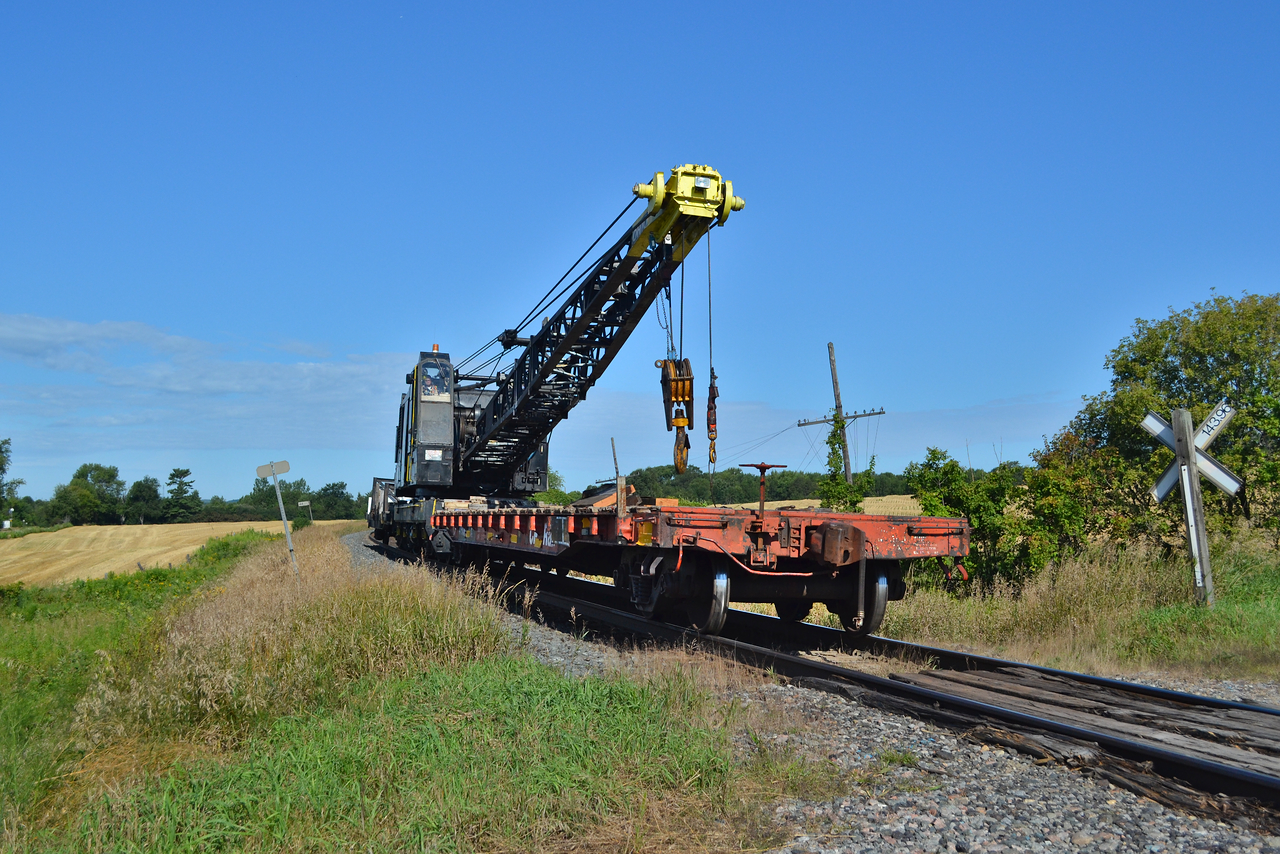 Not exactly something you see every day. Digging through my old laptop in hopes of finding lost images, to no real success. I found these old shots of this MOW crane and old flat car working West towards Port Hope. Never saw this kind of move again. The overgrown codeline pole was a nice touch.