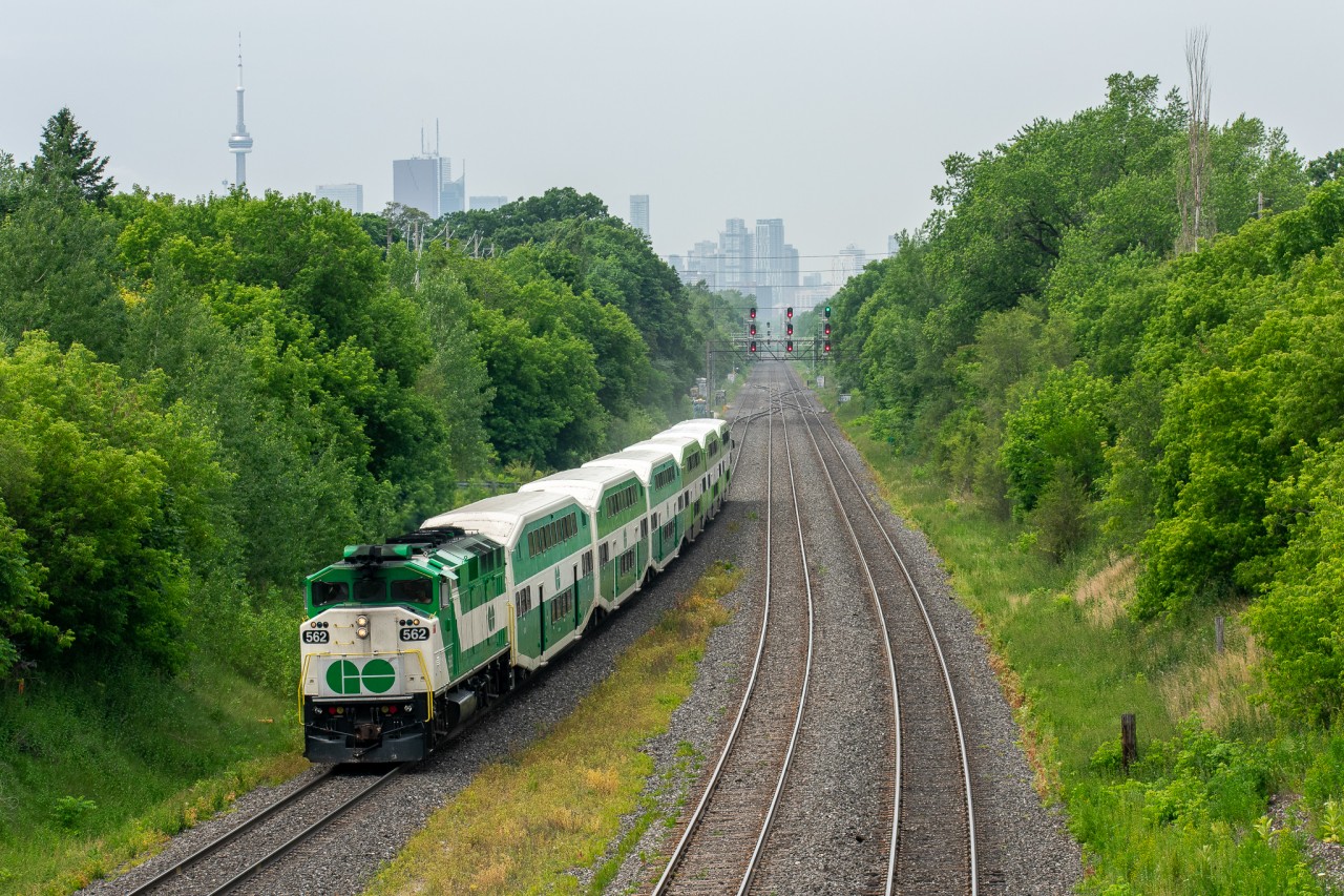 GO F59PH 562 takes the lead of a Lakeshore East train towards Oshawa about to make its first stop at Danforth. Not only is it typically uncommon to see F59s running on the Lakeshore East (although has become more common this year with 6 car trains on all lines) but also is very rare to see them using the class lights. Since the white and green ones basically serve no purpose anymore, the only time you see them on is when the crew is having some fun pretty much, I assume that was the case here :P! To top this shot off, the CN Tower triumphantly stands in the background.