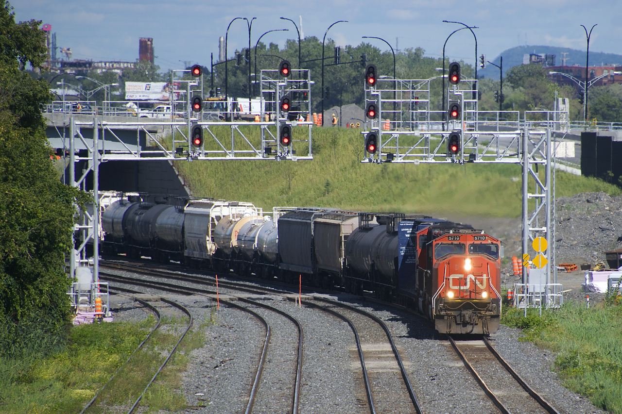 CN X323 has a pair of SD75I's (CN 5710 & CN 5716) as it heads west under a pair of signal gantries near Turcot Ouest. After running as X324 the day before and spending the night in Vermont, the crews run is nearly over.