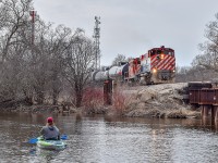 I believe this train was actually Job 2, the Job that worked the south end of Guelph. Although at the time I didn't realize it was. After finishing switching the PDI Liquids facility, they headed south light power. While switching a couple guys in kayaks went paddling by, obviously one of them found the train as interesting as me, as he stayed there watching the train for a little while.