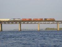 CP 9832, CP 8916, CP 8942 & CMQ 9020 lead CP 251 over the St. Lawrence River as it is illuminated by the morning sun.