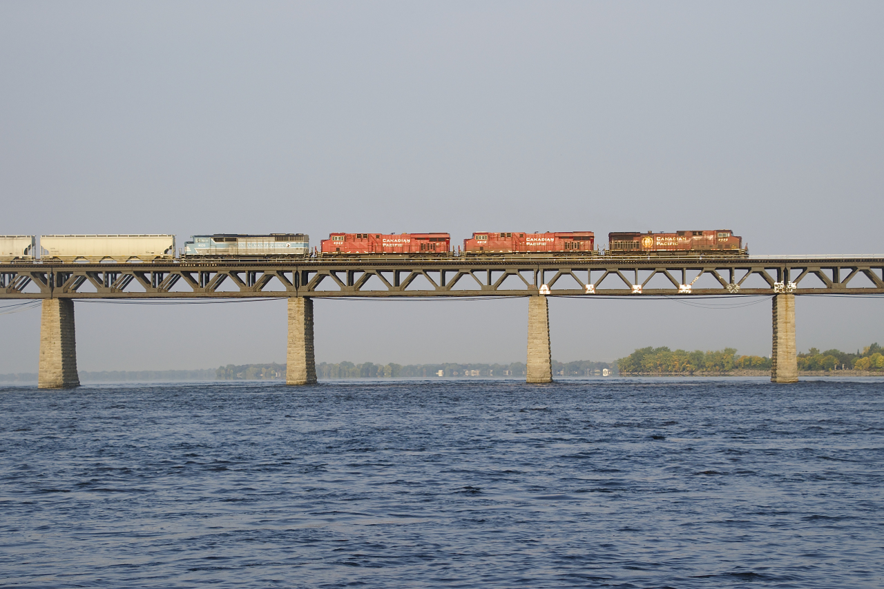 CP 9832, CP 8916, CP 8942 & CMQ 9020 lead CP 251 over the St. Lawrence River as it is illuminated by the morning sun.