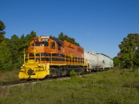 GEXR 583 shoves back across Carter Road into the north siding at Arkell in the evening sun after lifting a few cars for PDI Elizabeth.  The crew would tie back onto their train and proceed northward to Guelph for the evening's work.<br><br>Carter Road (mile 27.55) marks the approximate boundary between the communities of Arkell and Farnham; a community that began years ago, but failed to fully materialize.  Farnham, originally Farnham Plains, was founded by John Arkell (1802-1881) who immigrated to the Puslinch area in 1831 from Kempsford, South Gloucestershire, England.  He would begin settling 1800 acres about 3/4 of a mile west of today's Arkell with his cousin Thomas Arkell.  An Anglican Church was built in 1854 beside the cemetery as the main component of the community, however few people remained in Farnham as Arkell prospered, likely in part to the coming of the Guelph Junction Railway in 1888.  The church building was moved to Arkell in 1901 as few people remained in Farnham; only the cemetery and <a href=http://www.puslinchhistorical.ca/img/Arkell1.jpg>Thomas Arkell's house</a> remain today.<br><br>The Canadian Pacific's <a href=https://i.pinimg.com/originals/6d/0c/e6/6d0ce61f1d750fa380bae73a6685b62e.jpg>Arkell station</a> was built in 1888 and <a href=http://www.trainweb.org/oldtimetrains/time/gandgtt1909.jpg>served the community</a> until passenger service ceased on Saturday, August 4, 1962.  Prior to this passenger service was typically operated using a <a href=http://www.trainweb.org/oldtimetrains/CPR_London/9002a.jpg>Battery Car,</a> often with CPR 9002, nicknamed "Old Sparky" by residents along the line.  Sparky would be replaced by <a href=http://www.trainweb.org/oldtimetrains/CPR_London/9004a.jpg>CPR 9004,</a> a gas-electric doodlebug in the 1940s until 1958 when <a href=http://www.trainweb.org/oldtimetrains/CPR_London/5405_psgr.jpg>steam powered mixed trains</a> would take over the passenger service.  Arkell station would be sold in 1963 to the Trustees of the Farnham Cemetery (still in use today) for use as a tool shed, but was later demolished and a <a href=https://farnhamcemetery.files.wordpress.com/2017/03/farnham-cemetery-montage-201.jpg?w=1040>replica was built</a> in it's place.