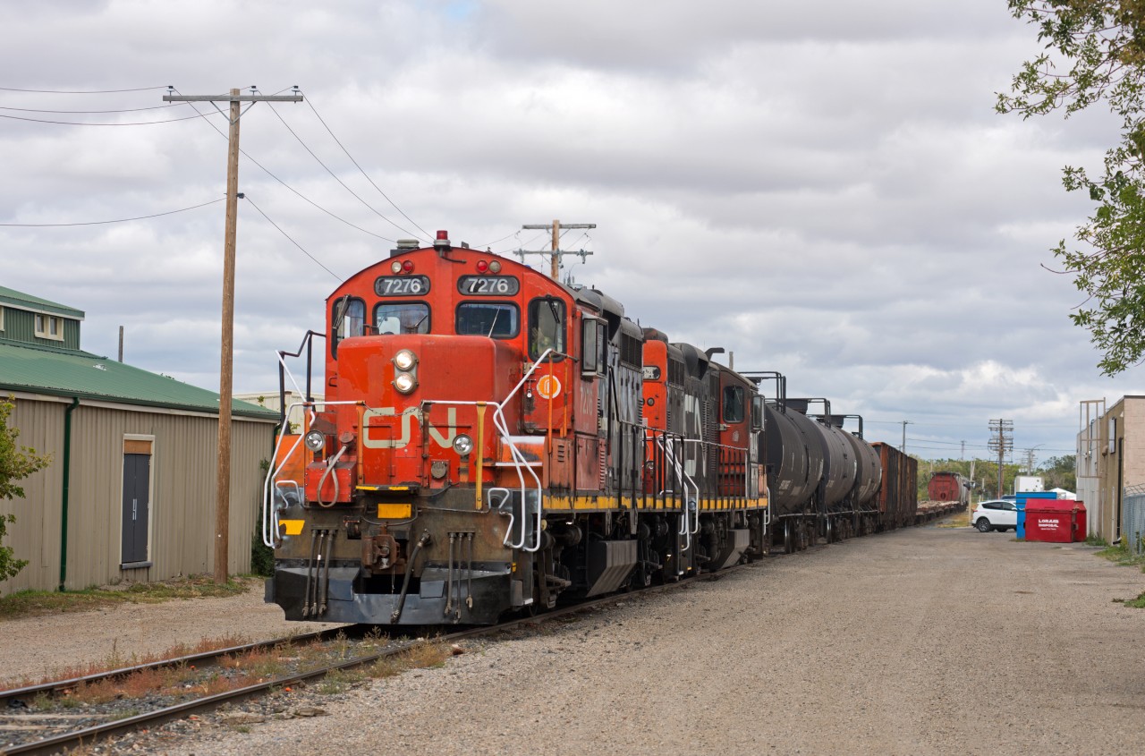 A pair of CN units on the endangered species list make their way through the back streets of Regina Saskatchewan with a cut of cars for the CP interchange.