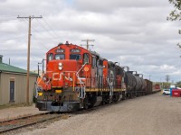 A pair of CN units on the endangered species list make their way through the back streets of Regina Saskatchewan with a cut of cars for the CP interchange. 