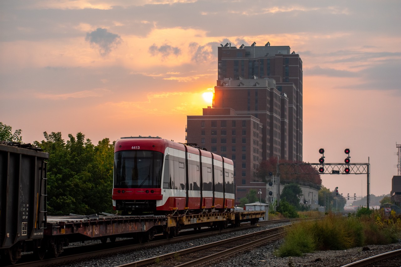 TTC Flexity Outlook streetcar #4413 hitches a ride on the back of train 247 as it departs Lambton for Agincourt. Earlier this day, the streetcar was lifted from TTC Hillcrest by the Lambton Yard engines and was brought to West Toronto to be lifted. After 247 dropped it in Agincourt it was seen the next day on I believe either 118 or 142 headed east on the Belleville Sub. I can only imagine it must've been destined for Bombardier's testing facility out east.