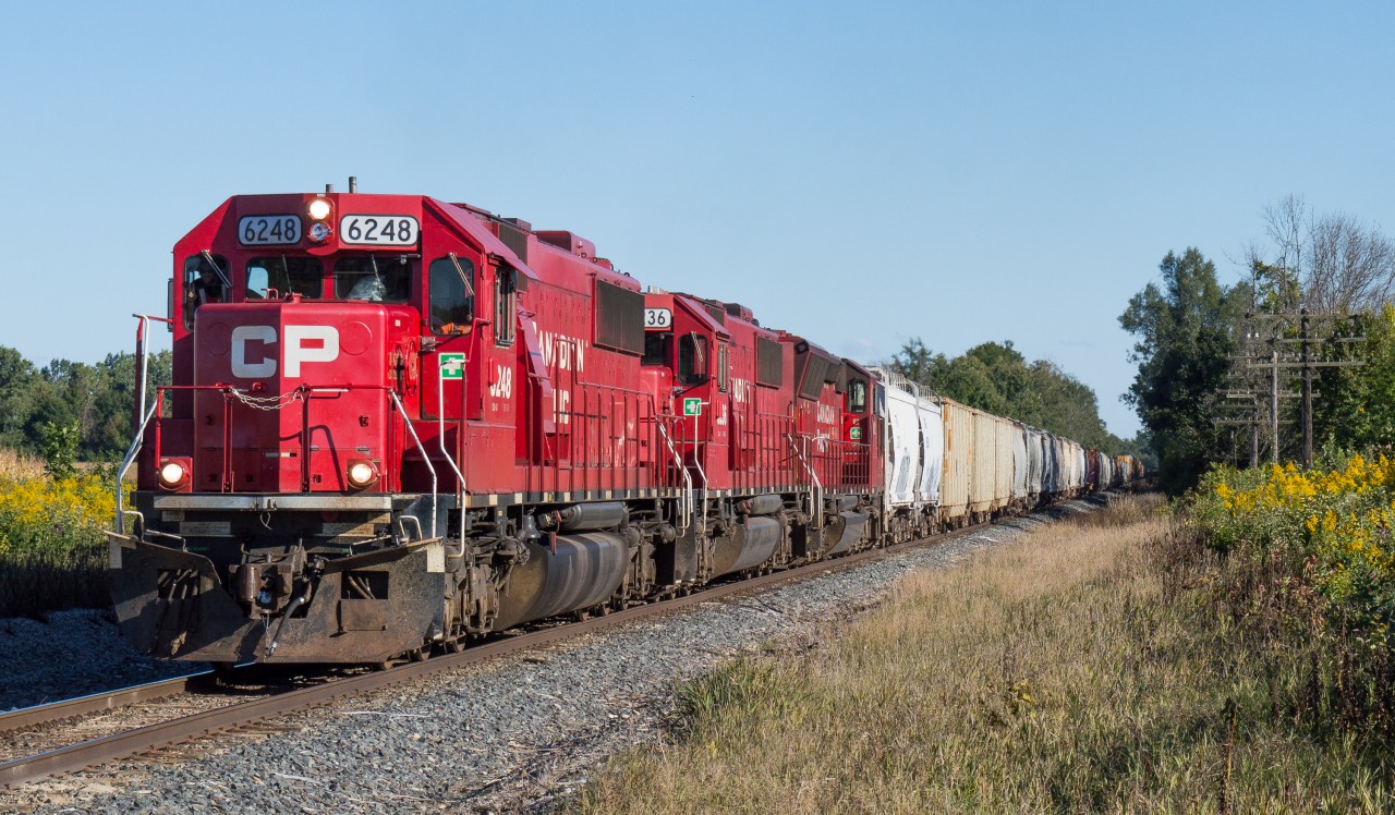 CP 255 is lead towards Concession 6 Side Road in Waterdown by the much photographed of late EMD trio.  With 9000' on the drawbar this was a heavy and long train so the EMD's put on quite the show.  A nice sunny fall afternoon made this shot well worth the drive.  Thanks for the motivation, Rob.