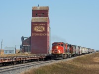 CN 556 accelerates past the picturesque elevator at Stony Beach with a fitting pair of SD40-2W's on the point and a train of empty grain cars for Moose Jaw in tow.  