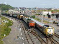 CN 305 is stopped and changing crews at Turcot Ouest as VIA 67 passes it on the north track of CN's Montreal Sub. VIA 62 had just passed on the south track a few minutes before.