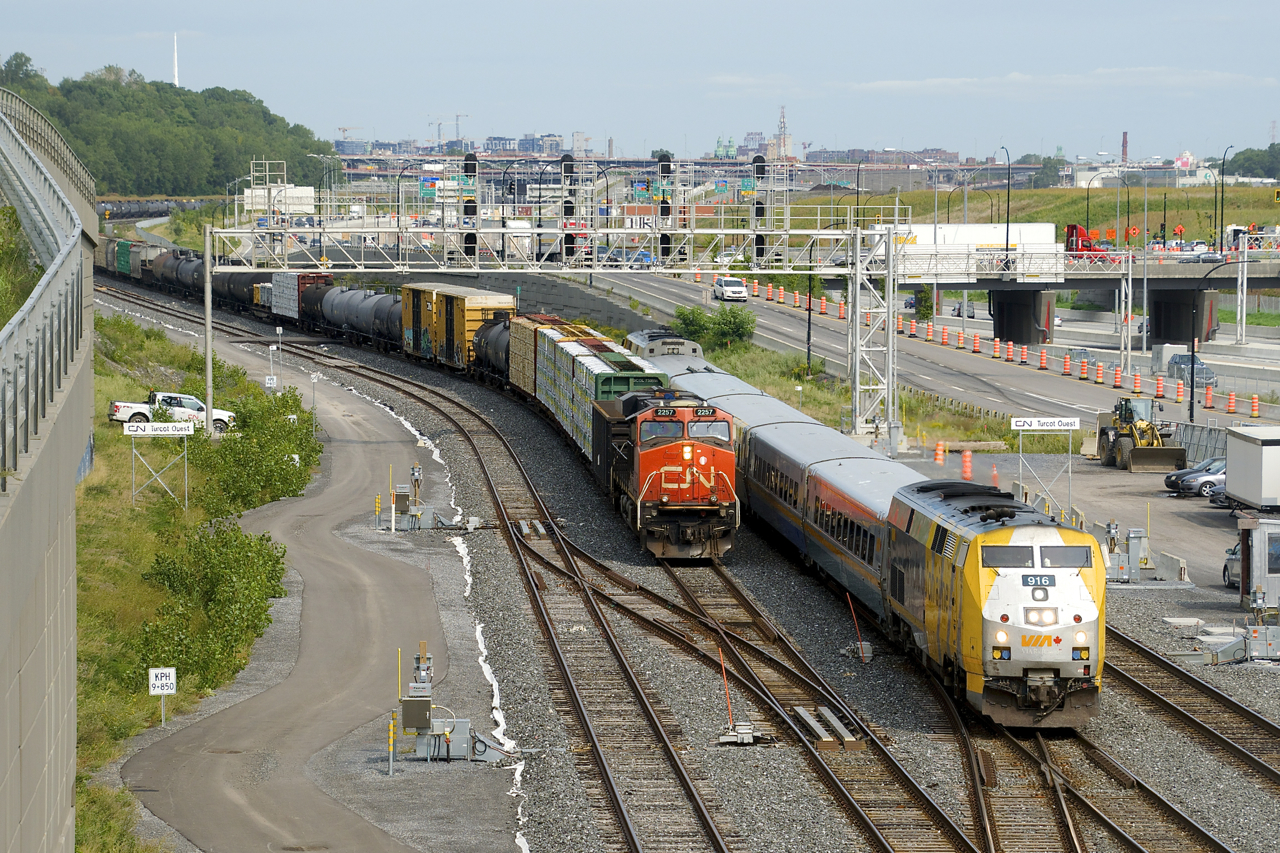 CN 305 is stopped and changing crews at Turcot Ouest as VIA 67 passes it on the north track of CN's Montreal Sub. VIA 62 had just passed on the south track a few minutes before.