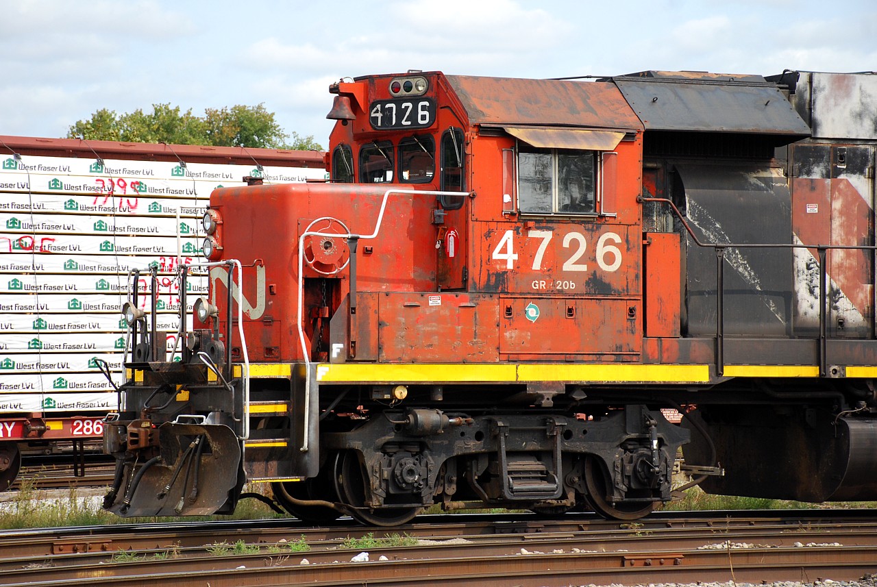 We've all seen our fair share of quick-fix replacement number boards; some are done quite well while others leave a lot to be desired. The classic cardboard and duct tape type come to mind.  CN 4726 has a pretty ugly replacement number board on the conductor's side.  It hasn't inspired me to go out of my way to photograph it until yesterday when I heard 580 blowing for Stanley Street when leaving work.  Upon reviewing those photos I noticed something interesting about that replacement number board.  The "6" looks like the font CP uses on their number boards.  Zooming in on the photo you can see the weird looking "4" was clearly made from a "1", and there's a faded "8" where the "7" is painted.  1800's were CP RS18u's.  So how did a CP RS18u number board end up on a CN GP38-2?  Then I recalled seeing a former New Brunswick East Coast Railway RS18u heading to Woodcrest (IL) for disposition after CN had reacquired the NBEC.  Looking closer at the number board, it looks like "1838" behind the crude "4726".  Sure enough NBEC 1838 was one of the RS18u's that went to Woodcrest and was scrapped!  So a little piece of a CP RS18u lives on.  Now that ugly looking number board is pretty interesting!  And if you're wondering why Woodcrest didn't just make a proper number board (assuming 4726 got the number board there), that's a good question!