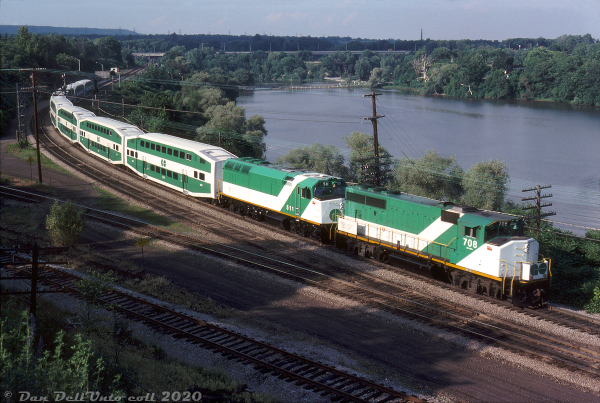 After finishing their evening run to Hamilton (James Street) station, an 8-car GO train departs eastbound, deadheading back to Willowbrook Yard via the CN Oakville Sub. GO GP40-2W 700 leads up front on the approach to Bayview Junction, with GP40-2W 708 and F40PH 511 seen bringing up the rear through Hamilton Junction. Three locomotives and eight bilevels might seem a bit overpowered, but at the time GO Transit's six new F40PH units (510-515) were only a month or two old, so 511 could be doing break-in or test runs before being released on its own (it would also be the only unit here able to provide HEP to the bilevels).

Reg Button photo, Dan Dell'Unto collection slide.