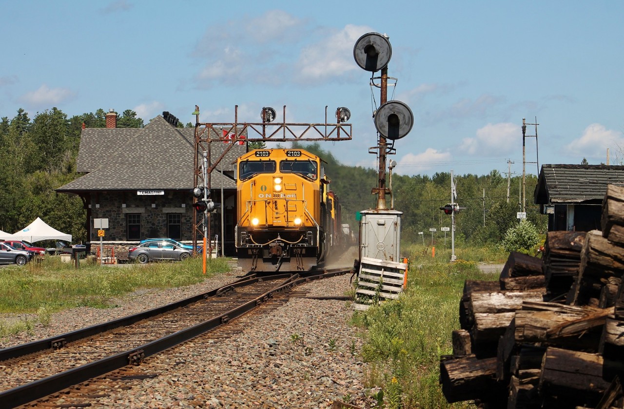 ONT 214 screams through the town of Temagami with one of their SD75Is on point. The station to the left was built in 1909 by the Temiskeming and Northern Ontario RR after the previous station burned down. I'm not sure how old the searchlights here are, but they've been out of service since the late 2000s. The crew of this train was amazing. If you look closely you can see the conductor making rowing gestures.
