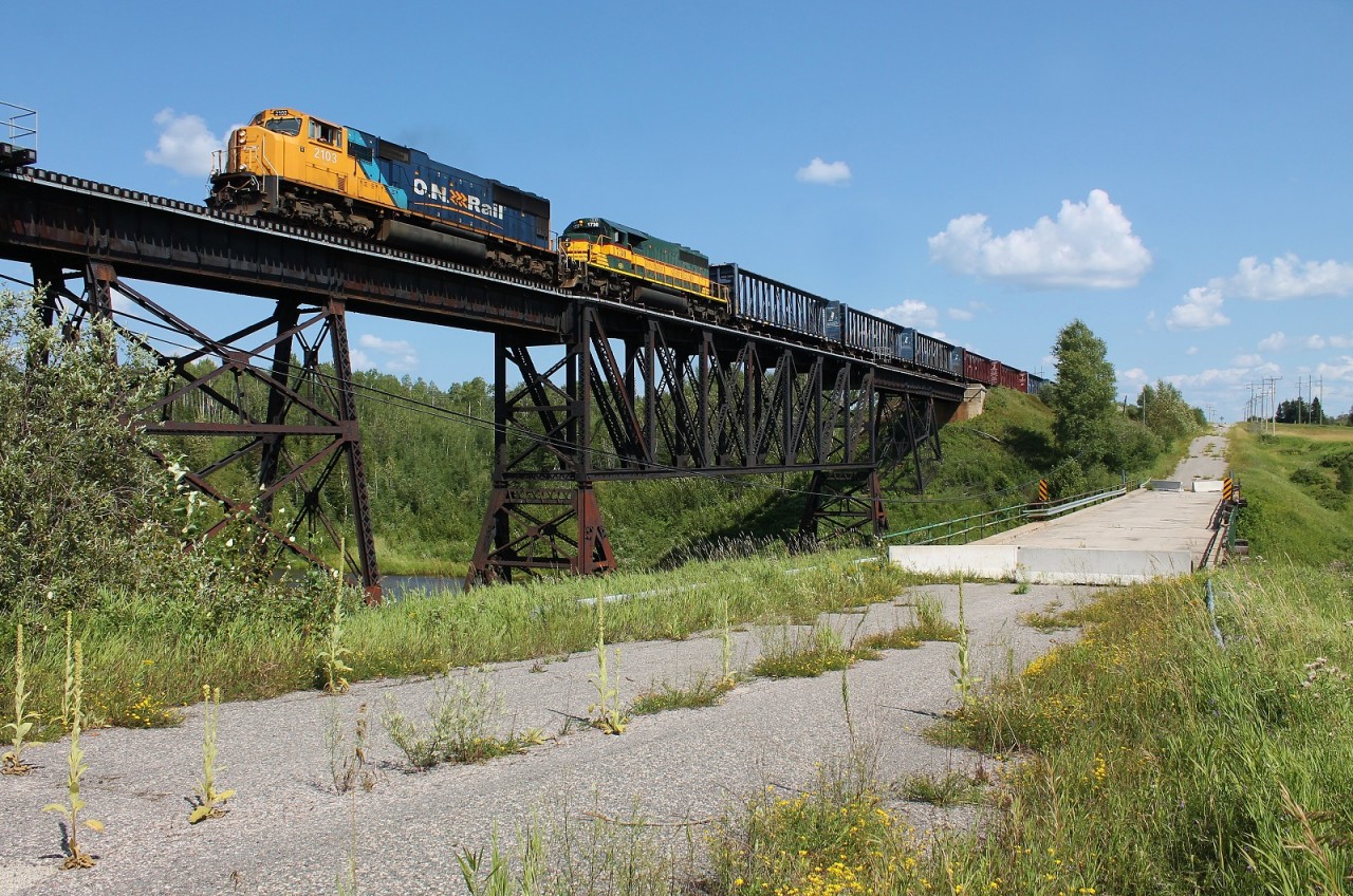 ONT 213 passes over the Driftwood River in the small village of Monteith which is part of the Municipality of Iroquois Falls. Behind the camera is the Monteith Correctional Complex. It was a WW2 POW camp and serves as a medium/maximum security prison today for Northeastern Ontario; so don't trespass here! The road bridge in the foreground has been closed to pedestrian and vehicle traffic for some time making it a bit inconvenient for chasing, but we made it work.