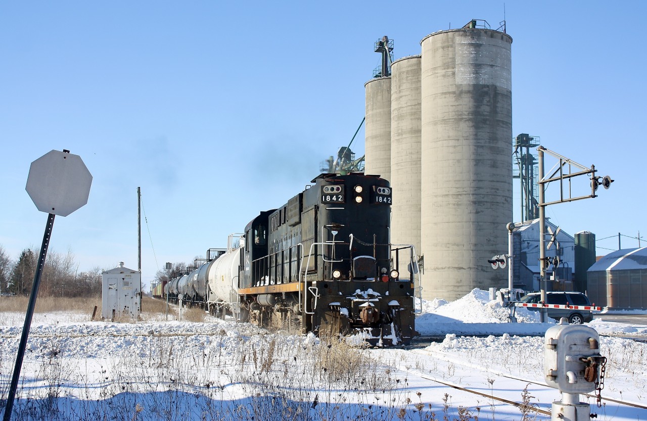 This was another somber event for myself, as I didn't start serious railfanning until the mid 1990's I missed out on all the regular train action on not just the Canada Southern, but CN's Cayuga Subdivision as well. When I finally made it to the area the CASO had been discontinued and the Cayuga had been freshly ripped out east of Delhi. Trillium was my one chance to photograph what was left of the Cayuga Subdivision and luckily I made a few trips to Tillsonburg to catch them. This trip to catch Trillium started in the dark of the early morning after finishing work. It was my second week in a row and I knew they most likely would only make one more trip before giving up the line. The fresh snow added to the occasion with a bit of drift busting along the way and at the time RS18 1842 (a former CP unit rebuilt from a retired CN unit) was usually the main power. The train is seen returning back to Tillsonburg and crossing regional road 73 in Alymer. The old elevator was once served by the railway but I heard it was demolished this past summer after OSR ran it's last train over the line. The faded stop sign and signal switch were used for the south service track that has since been ripped out. Trillium would run at least one more time over the line and to many people's surprise OSR would briefly revive the line thanks mainly due to an odd twist if fate that found their bridge in Tillsonburg taken out of service and too costly to fix. Running the Cayuga Subdivision allowed them to continue serving customers on the south side of town as well as further east. As we all know this arrangement only lasted a few years and today the Cayuga Subdivision sits lifeless once again, this time most likely for good.