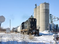 This was another somber event for myself, as I didn't start serious railfanning until the mid 1990's I missed out on all the regular train action on not just the Canada Southern, but CN's Cayuga Subdivision as well. When I finally made it to the area the CASO had been discontinued and the Cayuga had been freshly ripped out east of Delhi. Trillium was my one chance to photograph what was left of the Cayuga Subdivision and luckily I made a few trips to Tillsonburg to catch them. This trip to catch Trillium started in the dark of the early morning after finishing work. It was my second week in a row and I knew they most likely would only make one more trip before giving up the line. The fresh snow added to the occasion with a bit of drift busting along the way and at the time RS18 1842 (a former CP unit rebuilt from a retired CN unit) was usually the main power. The train is seen returning back to Tillsonburg and crossing regional road 73 in Alymer. The old elevator was once served by the railway but I heard it was demolished this past summer after OSR ran it's last train over the line. The faded stop sign and signal switch were used for the south service track that has since been ripped out. Trillium would run at least one more time over the line and to many people's surprise OSR would briefly revive the line thanks mainly due to an odd twist if fate that found their bridge in Tillsonburg taken out of service and too costly to fix. Running the Cayuga Subdivision allowed them to continue serving customers on the south side of town as well as further east. As we all know this arrangement only lasted a few years and today the Cayuga Subdivision sits lifeless once again, this time most likely for good.
