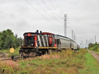 GMD1, CN 1408, backs in to the siding along Edinburgh Road in Guelph to retrieve the remainder of its load. The crew was just hoping to get the load up the hill to the yard with the single powered train in the light rain. They would then work the yard for several hours more.