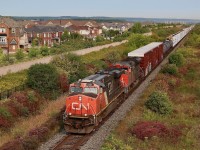 With the countless number of Gevo's out on the road, I have always taken a liking to the original group that featured the nose mounted marker lights and odd rear headlight placement. They just seemed to stand out in the crowd. I also wish this vantage point in Milton existed long before urban sprawl took over, including a nice uncluttered view of the Niagara Escarpment, nevertheless this has for a number of years been one of my favourite locations in town. Here CN 421 with a 2+2(DPU) consist heads out of town and is about to pass a whole new area of development, including what is supposed to become a new intermodal yard for CN in the future.