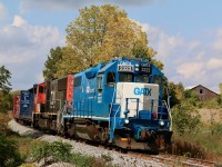 In all of these years of railfanning I have only had the opportunity of following trains on the Hagersville subdivision a few times. Since CN gave up the line in the late 1990's most trains have traveled the north end of the line under the cover of darkness, now that CN is back again daylight moves are most common. I'm not totally sure why but the last couple of trains I have photographed along the line have only traveled at a painful 5-10 mph. I'm not sure if is due to the lack of an "end of train device" or due to the condition of the rails. Nevertheless it makes railfanning a lot easier. Here train 580 with a GP38 / SD75 combination are passing an old barn and some changing fall colours just southeast of Cainsville. I never realized the photo opportunities along this stretch of the line with some nice rolling hills and rural crossings. I will definitely try this again when I have more time and less cloud cover. 