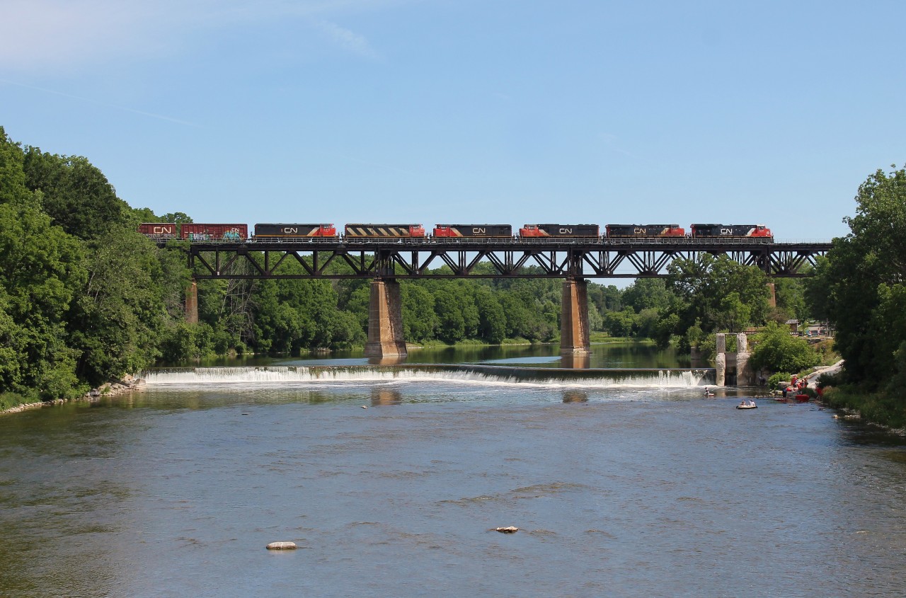 CN M394 heads east over the Grand River in Paris, ON with a trio of retired cowls DIT. 

(BCOL 4621 (C40-8M), CN 2406 (C40-8M), & BCOL 4615 (C40-8M))