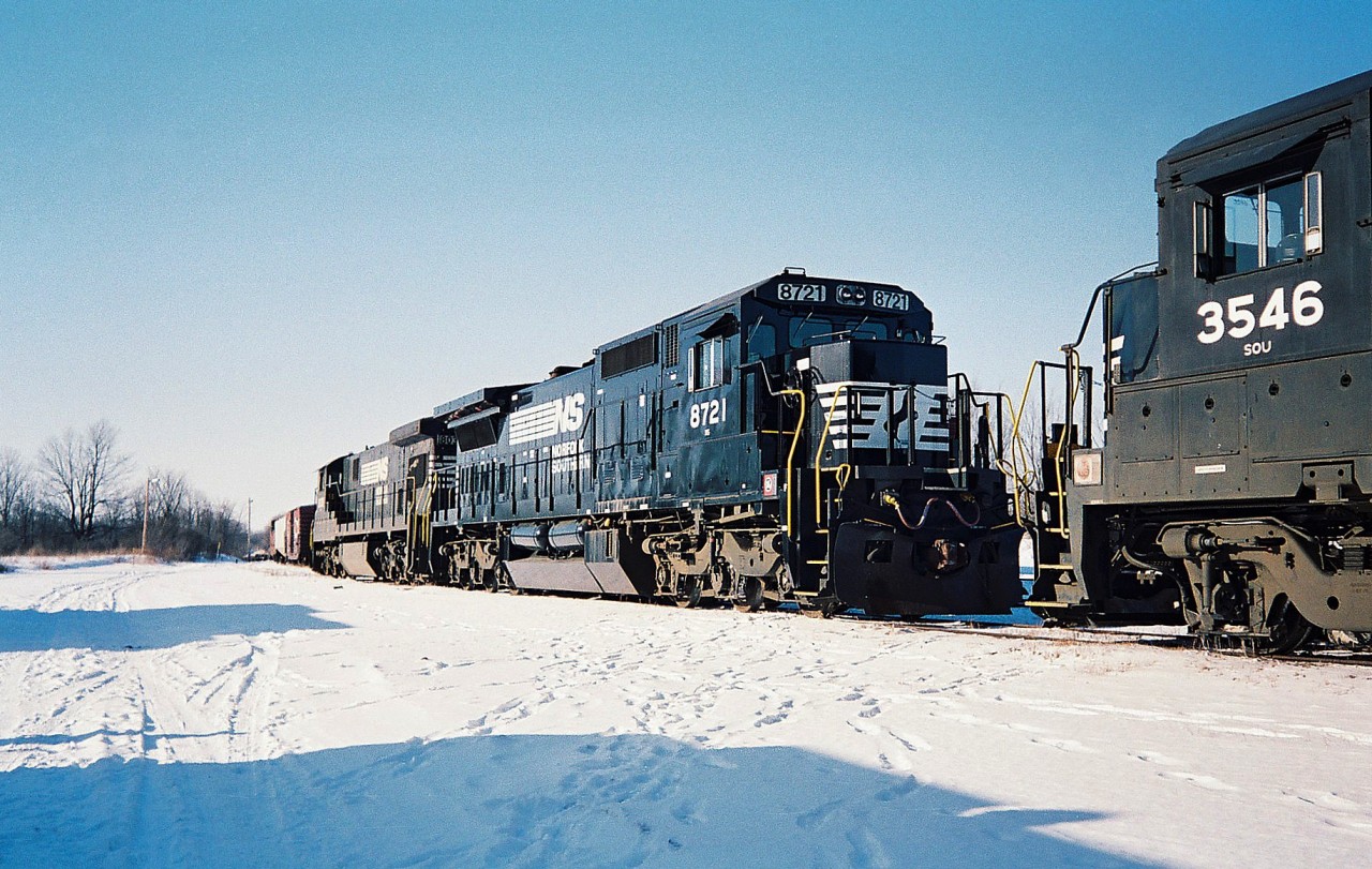 Norfolk Southern 8721 and 8038 have just arrived off a train and are seen tied down in the CN yard in St. Thomas. The other consist there that day was NS 3546 and 6624. At the time, usually at least two NS power sets could be found between assignments in St. Thomas for their auto trains that operated on the CN Paynes and Cayuga Subdivisions.