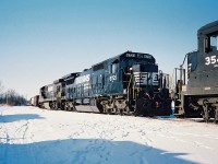 Norfolk Southern 8721 and 8038 have just arrived off a train and are seen tied down in the CN yard in St. Thomas. The other consist there that day was NS 3546 and 6624. At the time, usually at least two NS power sets could be found between assignments in St. Thomas for their auto trains that operated on the CN Paynes and Cayuga Subdivisions. 