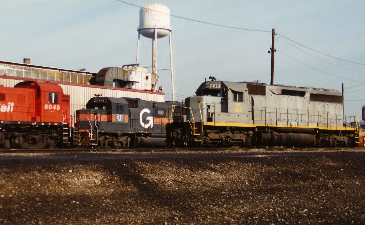 PNC 3011 and HATX 511 as well as several CP units await their next assignment at CP's Toronto Yard diesel facility. This was during the great CP lease fleet era of the mid-1990's when the railway was leasing hundreds of unit's from various companies.