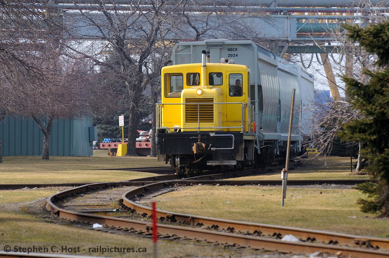 For Larry and James, Here's a photo I might be able to re-do soon, NSC pushing across the unprotected crossing (industrial track) out front of Dofasco, NSC 11 is shoving a cut of cars onto the coke oven leads for storage. Moves here still happen, Saw it last weekend while driving through but was unable to get a shot. Next time.