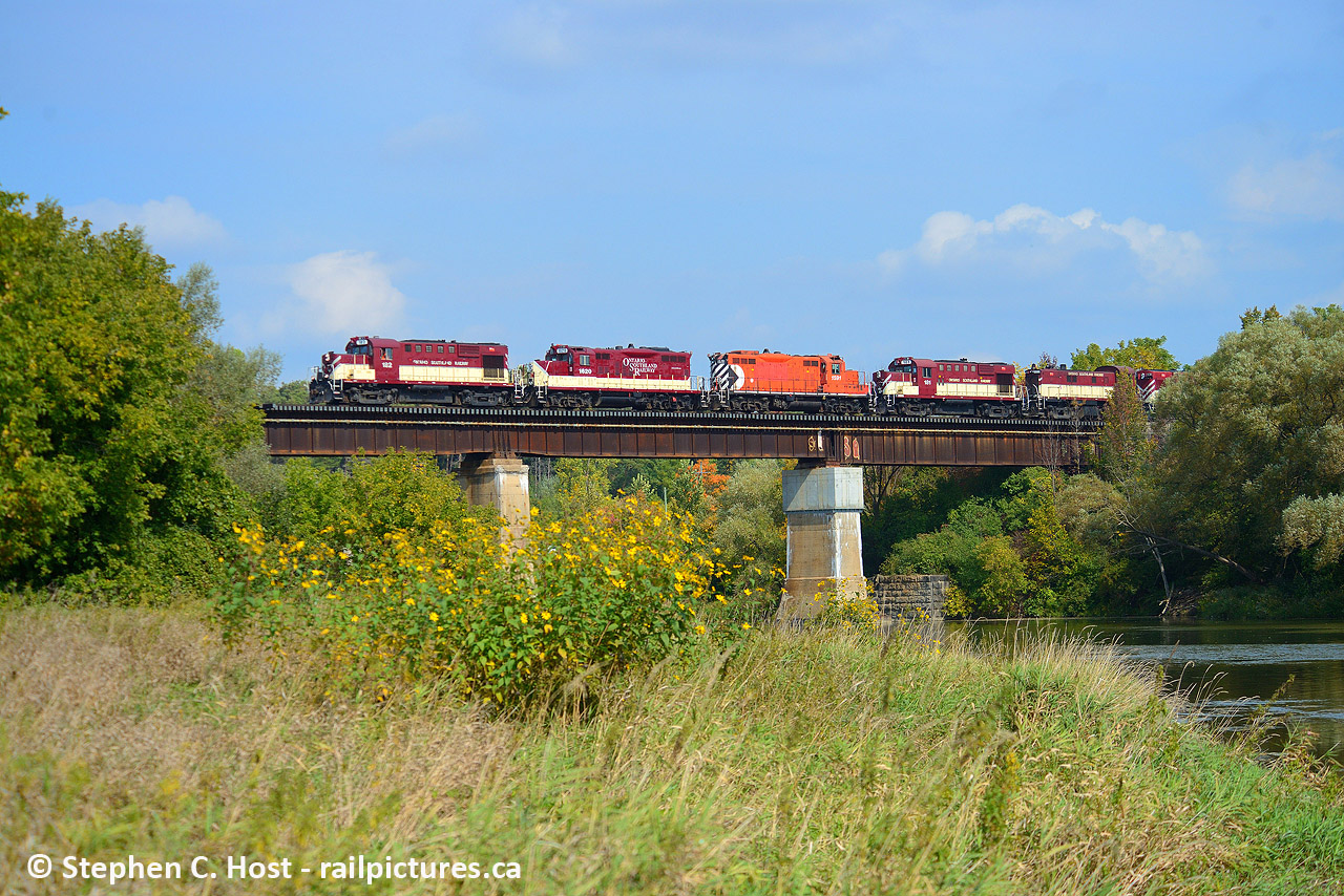 MLW's return to the Guelph Subdivision. OSR's hospital train with CN Engineer Chris Widmeyer at the throttle is seen passing over the beautiful Grand River Bridge in Breslau with the hopes of making it to Salford, Ontario.
Nothing ever goes according to plan. At the last minute CN was ready to do this move after waiting almost a month. Surprise was they wanted to do it without a CN leader. CN Crew was ordered 0600, but there was a paperwork snafu, no paperwork for the consist. First delay. CN made paperwork and gave it to the crew by 0900 who then made it over to Guelph in a Taxi. OSR had attached their SBU earlier in the morning, but CN could not get it to work. (Second delay). Since that didn't work, they had to go grab another SBU from 542 to test it, which took 30 minutes (Third delay), and that didn't work, so the train was now limited to 15 MPH on the mainline (Fourth). You can see it's already getting quite bad. However, after the train went to the Junction (with 542 pushing on the rear) and was about to go on the main, they called foremen who told them more delays were pending. So it was time to tell this to the trainmaster, and the crew called the RTC to re-lay information  to the CN Trainmaster. This is exactly what was heard over the radio. "So your IDU is not working, you are delayed by a foreman for 30 minutes, and after that you'll be delayed again for 60 minutes for another foreman, and you want me to tell this to the trainmaster, over?" At this time it is 12 PM and the train's supposed to go to London with a crew who was ordered at 0600
They only made it to Kitchener.