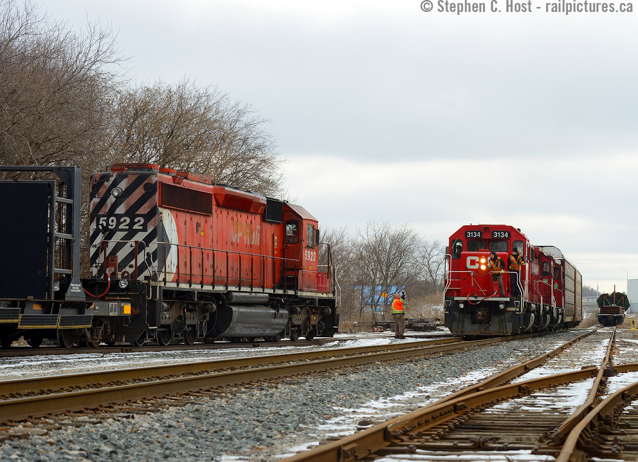 Crew from a rail train wave at the crew of T72 as they exchange pleasantries meeting on the CPR Waterloo Subdivision just north of the Highway 24 overpass. A rare place for two trains to meet, but the work train basically ducked out of the way here to meet T72 as they had to work on the Galt. The Fergus sub from Concession ave to the switch pictures here is leased by the CPR, and CNR has access to the BWXT tracks (at right) to serve as a customer, but they have yet to do so since GEXR left town.