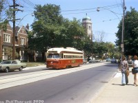 Pedestrians in typical 70's attire, cyclists and motorists enjoy a warm summer afternoon along St. Clair Avenue East as a TTC streetcar passes by, heading westbound past Clifton Road after coming back down Mount Pleasant from Eglinton Loop. In the background the top of Our Lady of Perpetual Help Catholic Church is visible, one of the local landmarks in the Moore Park neighbourhood. Sliding the window next to your seat up was de rigueur when it came to air conditioning on hot days. The side advert announces to passerbys that the new Galleria Shopping Centre would be having its grand opening on August 15th, 1972.<br><br>Wychwood Carhouse was assigned the St. Clair streetcar route, and their 4500-series A8-class PCC streetcars, like car 4545, were regulars on the route. They were the newest PCC's in the fleet (built 1951), even though the TTC would acquire a sizable fleet of secondhand cars from US cities in the immediate years following their purchase.<br><br><i>Photographer unknown, Dan Dell'Unto collection slide</i>