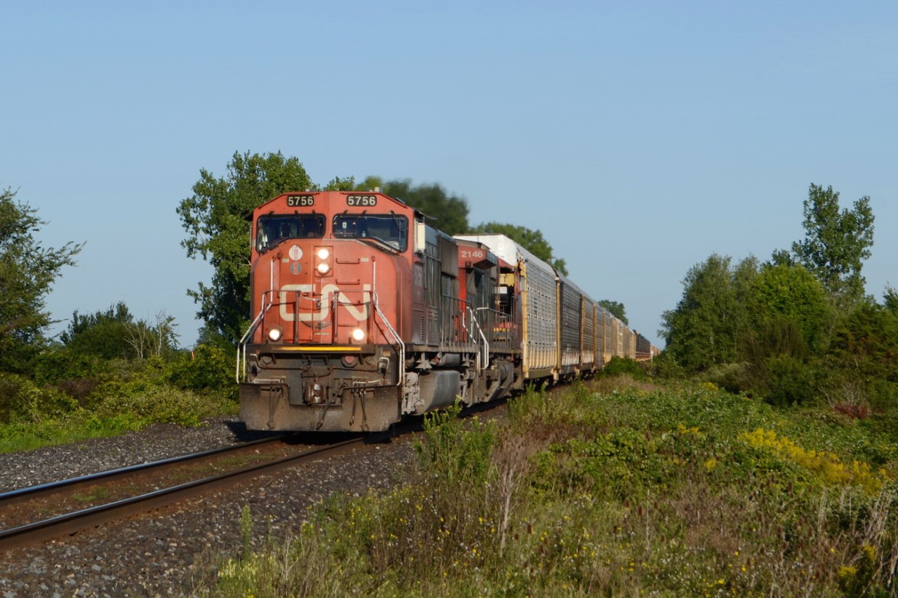 CN train E275 pulling down into Sarnia, after being stopped outside of town, while they made some room. CN 5756 and CN 2146, pulled a train of 2/3 autos racks, both loads and empties, and 1/3 of mix freight, which was lots of Bulk loads of lumber and truck frame on flat cars.