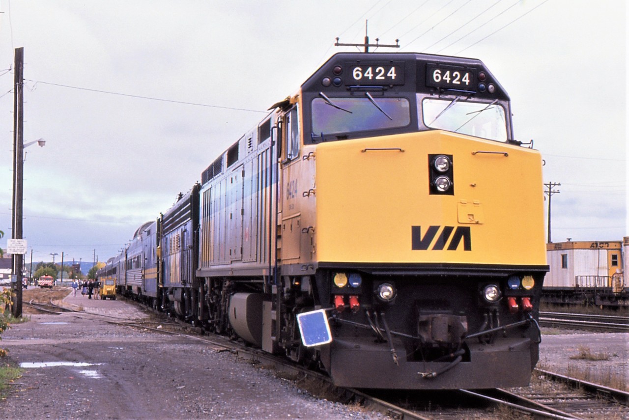 TRAIN TIME AT THUNDER BAY - Approaching the halfway mark of their first transcontinental train trip that started in North Sydney some 32 years ago, the photographer and his girlfriend take the time to stretch their legs at Thunder Bay. VIA Rail F40PH # 6424 pauses with the rest of the consist of # 1 at the impressive Station in the town that was once known in the geography books as as Fort William. Having departed Ottawa the previous day, an early morning rise afforded them amazing views of Lake Superior from the Canadian Pacific tracks. It was also an indicator of the vastness of Canada, as it took nearly 24 hours of continuous travel to reach the Manitoba border later that day.