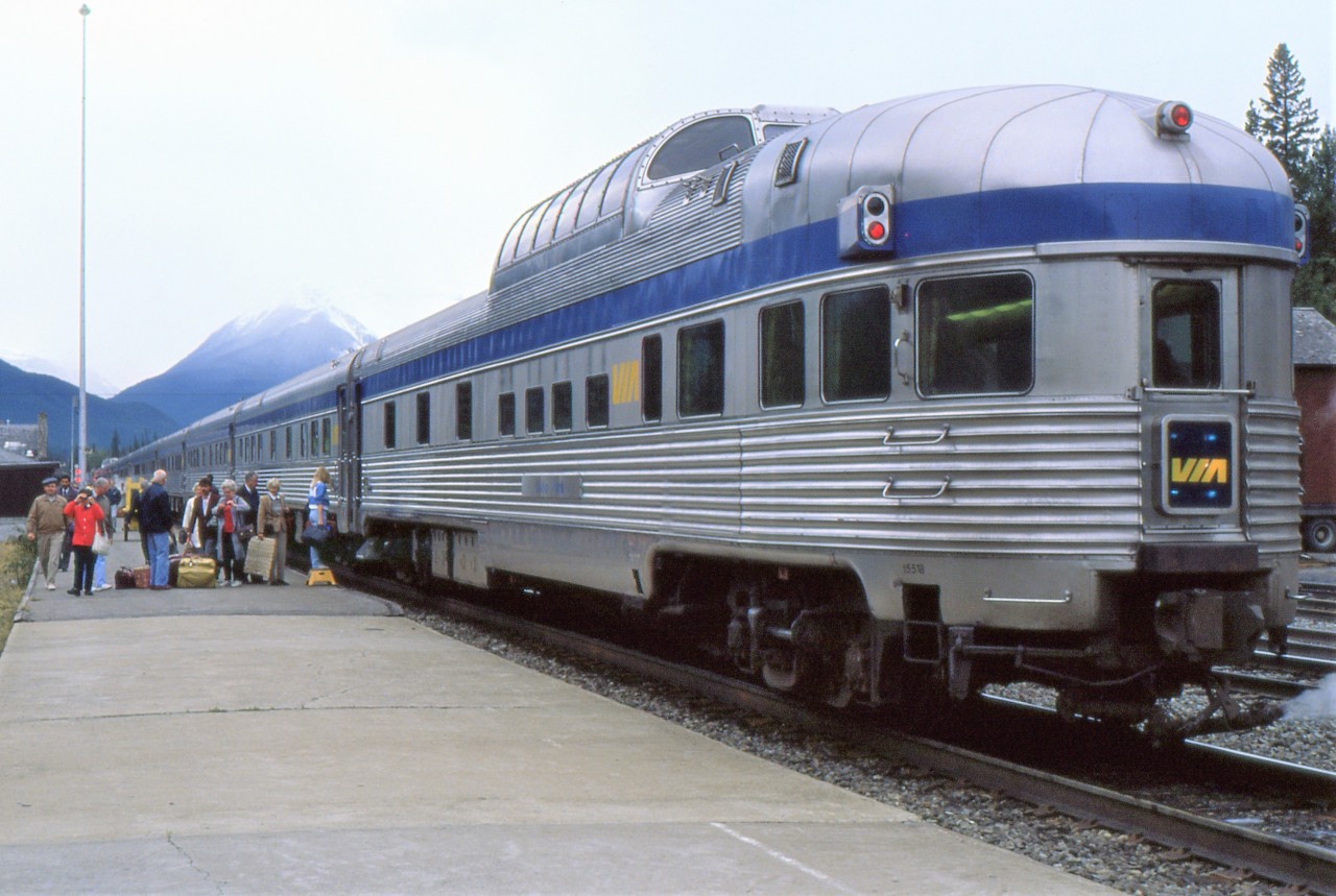 BOARDING AT BANFF - During its short stop at Banff on September 24, 1988, the photographer jumps off to capture this image of the dome observation car Yoho Park bringing up the rear of the westbound Canadian while several tourists entrain for the overnight journey to Vancouver. Within moments, he too will join his girlfriend on board and by the time they reach Revelstoke, she will have accepted his proposal of marriage in the dining car with a ring he kept hidden since the commencement of their journey from his native Newfoundland.