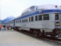 BOARDING AT BANFF - During its short stop at Banff on September 24, 1988, the photographer jumps off to capture this image of the dome observation car Yoho Park bringing up the rear of the westbound Canadian while several tourists entrain for the overnight journey to Vancouver. Within moments, he too will join his girlfriend on board and by the time they reach Revelstoke, she will have accepted his proposal of marriage in the dining car with a ring he kept hidden since the commencement of their journey from his native Newfoundland.