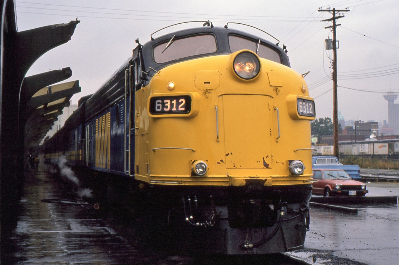 SUPER CONTINENTAL SUNDAY - After arriving in Vancouver the previous day on the Canadian, the photographer and his now fiancée prepare to board VIA # 4, the Eastbound Super Continental to work their way back to Newfoundland. This trip was part of a long planned rail journey to celebrate his graduation from Memorial University and a proposal of marriage in the Rockies at the same time. Delighted to see that the head end power that day was 6312, originally built in March of 1957 as 6523 but rebuilt in December of 1984 with the new number and designation. This classic engine would later be sold to Ontario Southland and changed to 1401. Wanting to ride as many different VIA routes as possible on their month long journey, they were waitlisted for a sleeper for nearly six months and learned just weeks before departure that space had opened up, such was the demand at the time for # 4.