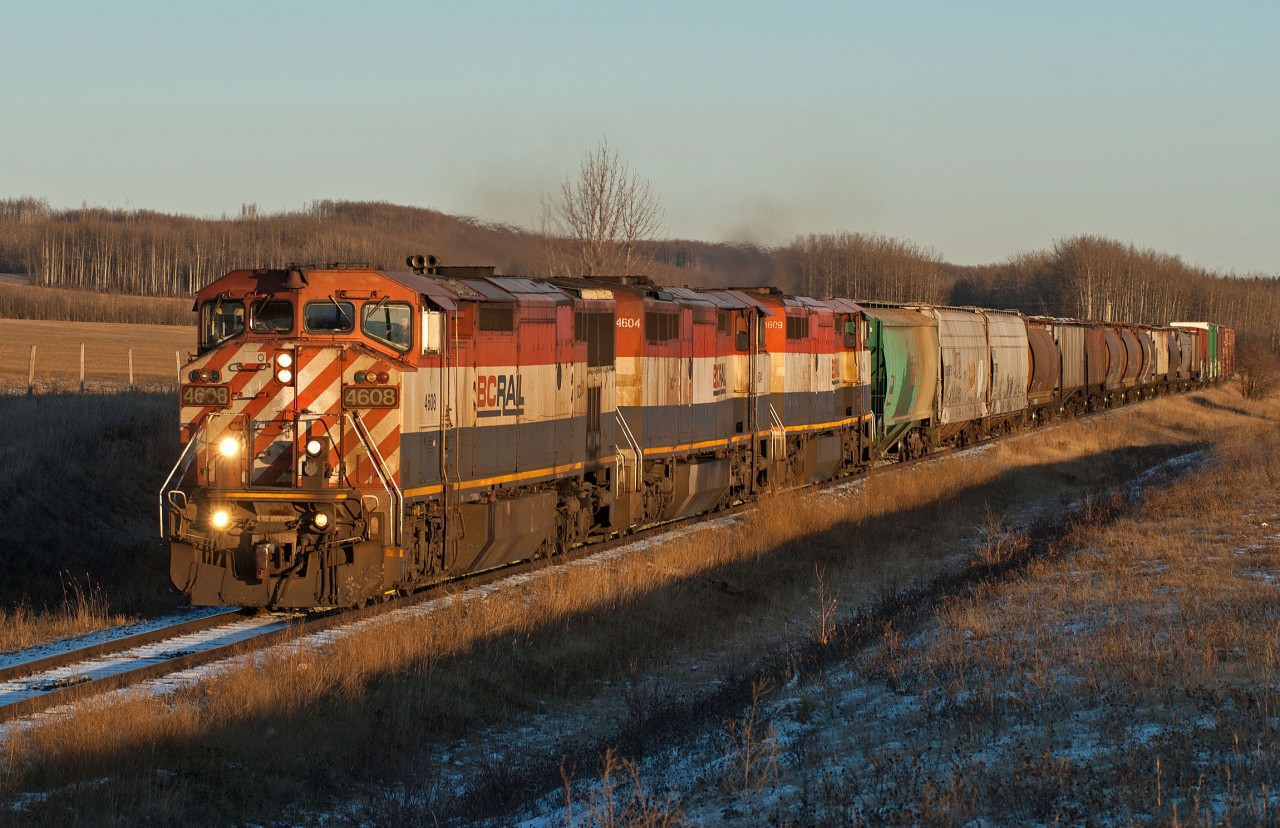 A solid set of BC Rail units on former BC Rail track might seem like a scene from a bygone era to the undiscerning observer.  In reality however this line, the Dawson Creek Subdivision, was four axle only territory in the BCR days and this is a uniquely CN scene. The BCOL 3900's held down this assignment till their retirement earlier in 2010 at which point the Dash8-40CM became the next best option and the subdivision timetable footnote read as follows: "Equipment Restrictions  Only the following units may be operated. Units in the number series 2400 and BCOL 4601 to 4625."  Given that the subdivision has three mountain grades and that 4600's have 4400HP unlike 2400's that only pack 4000HP, 4600s were soon the standard power for the 578/579 assignment. In this scene 4608, 4604, and 4609 make their way past the rural community of Groundbirch on their return trip to Chetwynd.