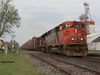 A CN westbound roars through the quiet community of Princeton, Ontario with SD50F 5513, an SD40-2, and a GP9 in the twilight hours of a spring day. 