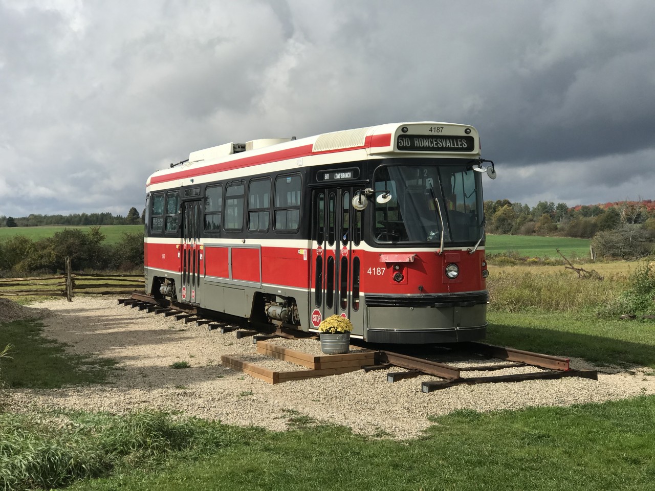 After a distinguished career in Toronto with the TTC, Canadian Light Rail Vehicle (CLRV) 4187 rests on Glista Family Farms in Priceville, Ontario. 4187 entered service in 1981, and was removed from service on December 29th, 2019. 

4187 was purchased at auction in late May 2020. On July 31st, 2020, it left the TTC’s Russel Yard for its new home in Priceville, Ontario. It was the last CLRV to leave TTC property. It is currently resting a mere 100 metres away from the former Canadian Pacific Walkerton Subdivision, which was torn up in 1984. In a roundabout way, trains have returned to Priceville. 

4187 will be restored and preserved, with no major alterations planned for it. Future work will include running electricity to the streetcar so that the lights, gong, roll signs, and the horn function. 

To follow the process of maintaining this iconic piece of Toronto transit history, on Instagram follow @Streetcar4187  https://instagram.com/streetcar4187