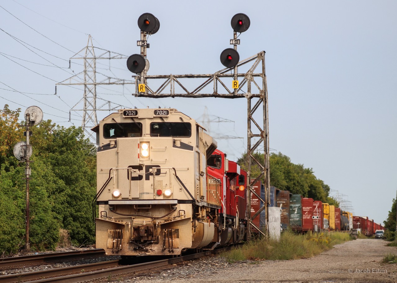 CP 421 seen passing through Bartlett with 7021 in the lead followed by 6259 and a 9300 series GEVO.