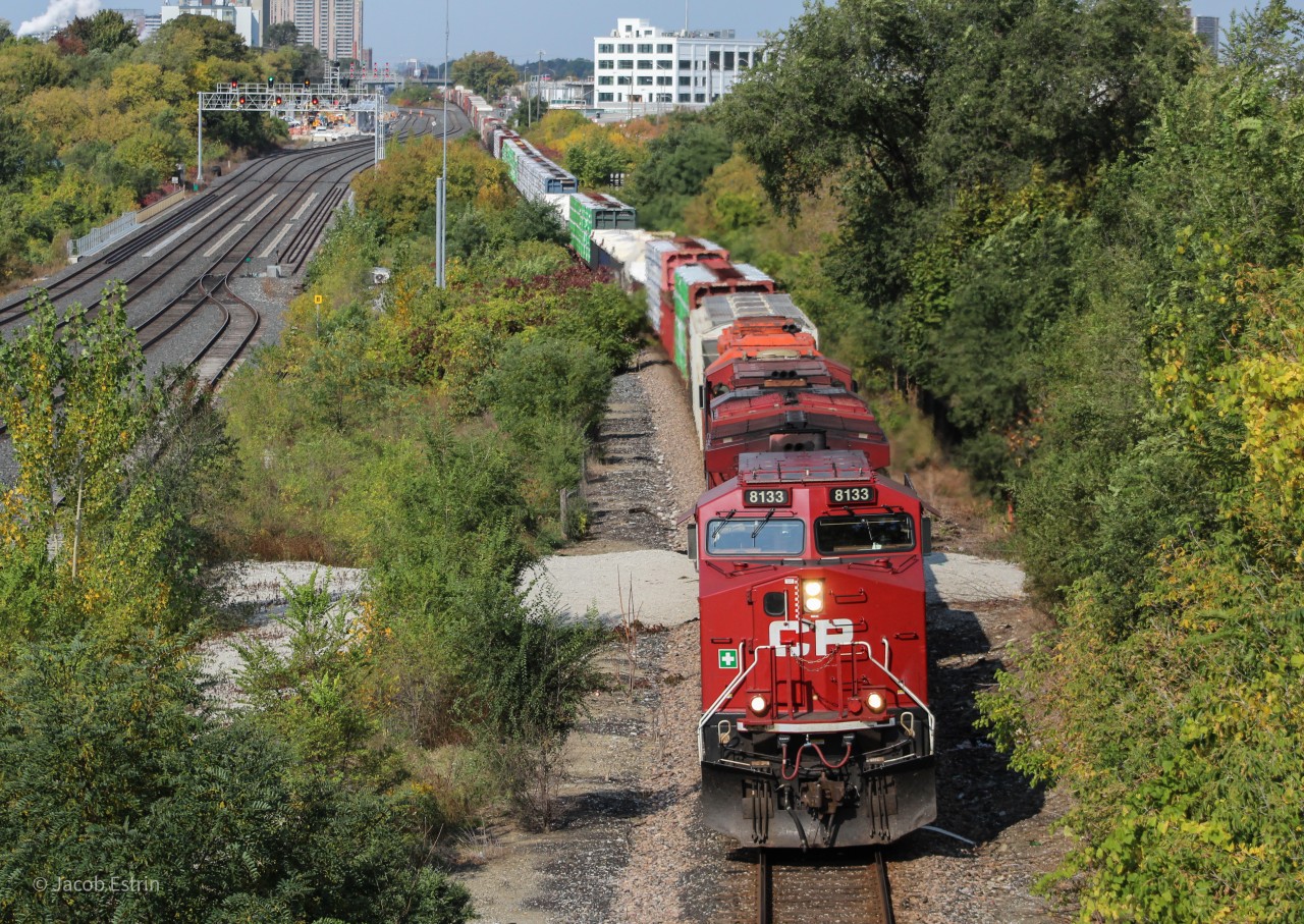 CP 8133 leads 420 under the Rogers Road Overpass with an Orange SD40-2 Dead in tow.