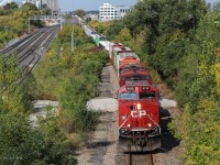 CP 8133 leads 420 under the Rogers Road Overpass with an Orange SD40-2 Dead in tow.