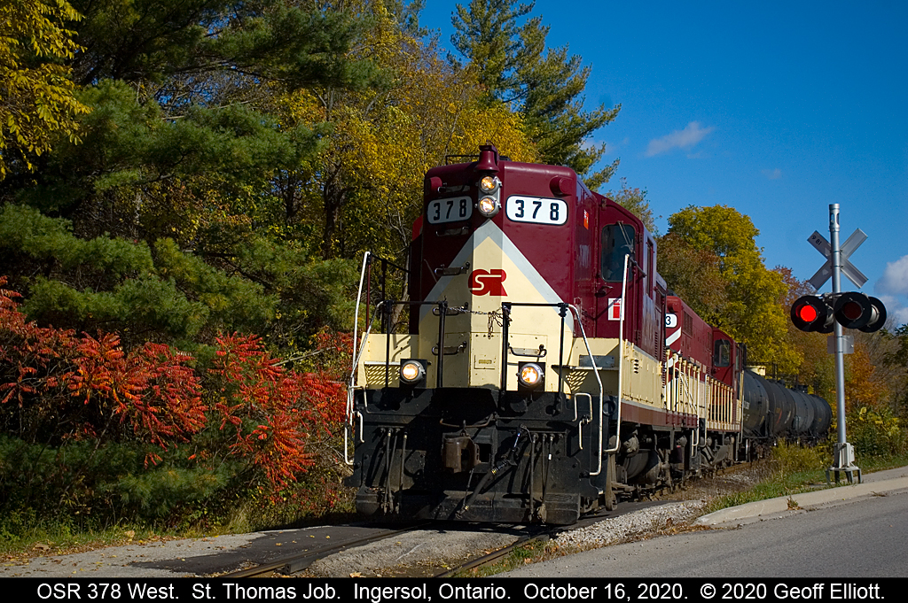 The St. Thomas job has returned north from Tillsonburg and is now headed west out of Ingersoll bound for St. Thomas.  378 is about to cross King Street and has 1 car on the tailend for the Woodstock job that will be setout at Cami for 6508 to lift as it heads east toward Woodstock later.