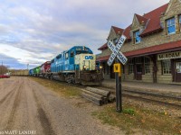 After a crew change, New Brunswick Southern Railway train 907 heads by the famous McAdam Railway station, and continues on towards the border into Maine. 