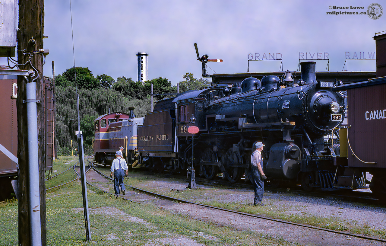 An extra train has been called at the CPR, former GRR/LE&N, shops in Preston on July 13, 1964, to deliver CPR D-10-g 4-6-0 894 (Angus Shops, 1911) to its new home at the Doone Heritage Village at the South end of Kitchener.  The hogger in the 6707 is seen waiting on the crew to finish looking over the 894 and van 435832 before getting underway to the CNR/CPR interchange just to the North of Queen Street South and Homewood Avenue (behind the now closed Nougat Bakery).  Formerly home to the Lake Erie & Northern and Grand River Railway Equipment, the Preston Shops, built in 1907, would serve into the 1960's as a locomotive shop for the SW1200RS units now working the line.  Eventually, the Preston based jobs would be moved to Galt, reducing Preston to a car shop until a fire destroyed the building in April, 1992.  The "Grand River Railways Shop" sign still survives today on the East end of Barn 2 at the Halton County Radial Railway.