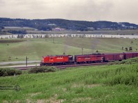 Rolling through Kelso Conservation Area, Extra 8785 west charges upgrade through Kelso with RS18 8785 and FPB-2 4466 up front.  Not much traffic can be seen passing Arawana Farms' barn on the 401 across Kelso Lake.  Built in 1958, 8785 would be rebuilt to CPR 1837 in 1987, and 1998 would be sold to the Minnesota Commercial Railroad as <a href=https://www.railpictures.net/photo/707231/>their number 83.</a>  B-unit 4466, built 1953, is just a few years away from retirement in 1976.  It will meet the scrapper's torch shortly after.