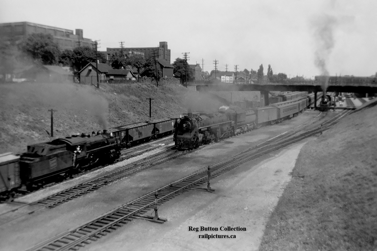 A busy scene at Hamilton's James Street North Station as CNR U-2-h 6263; the second last 4-8-4 Confederation type constructed for the CNR by MLW in 1944, hauls a good size passenger train westbound under MacNab Street North.  At left a freight passes eastbound, while at right in the station a CNR U-1-f "Bullet Nosed Betty" (CNR 6060-6079; MLW, 1944) sits waiting to depart.Opening in 1931, the James Street North Station served as the third station on what once was "Hamilton's Railway."  The original, built circa 1854 by the Great Western Railway (headquartered in Hamilton) served the railway until 1875, when the second station was built to accommodate the growth of the railway.  GWR would only use the new station for 7 years however, as the GTR would take control of the company on August 12, 1882.  Ground was broken on James Street North by the Canadian National Railways in 1929 for the new station, which would serve the company as well as VIA Rail, GO Transit and Amtrak trains over the years before closing officially on February 26, 1993.  VIA and Amtrak had moved to the new Aldershot station effective May 25, 1992, leaving only GO Transit serving the station until moving to the TH&B Hunter Street Station in early 1993.  In 2000, LIUNA; the Laborers' International Union of North America, would reopen the station as the LIUNA Station Banquet Hall.  In recent years this area has seen passenger trains stopping again with the opening of GO Transit's West Harbour GO Station in 2015.*Note the dual gauge tracks in the 'original' GWR station photo.  Beginning in 1870, GWR began rebuilding their line from Provincial gauge (5' - 6") to standard gauge for increased traffic from American rails.More James Street North Station:GO Transit in 1991 by John Eull.Amtrak's "The Maple Leaf" in 1992 by Bill MacArthur.A CNR 6167 excursion in 1963 by Harold E. Brouse.
Eastbound Amtrak in 1986 by John Eull.RARE COLOUR PHOTO; General Motor's "Train of Tomorrow" or Aerotrain in 1957 by Doug Page.