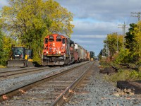 With its original post rebuild number boards, CN 4102 paired with 4725 switches out the west end of Kitchener as 568 setting up cars to go down the Huron Park Spur for Ampacet and CP. The new signal set on the right (another on the left blocked by 568) guards the new crossover that’ll be put between Lancaster and St Leger Streets that will be used by GO when needed and also to prevent west bound movements to the Huron Park Spur from pulling all the way to the single track at Kitchener West, shoving back to the switch then pulling down the Huron Park as there is no crossover from north to south between Kitchener West and the yard. The crossover is now in place at the moment, but I don’t think it’s in service yet. This is 4102’s first run at Kitchener since the CN takeover 2 years ago and it is the gloomiest time of the year unfortunately so getting anything in perfect sun this time of the year is decently tricky. If I recall correctly, there hasn’t been more than 5 perfectly sunny days since this shot so I was pleased with the result including the threatening sky in the background from the last night’s rain. As I type this though, Mr Sun is trying to tell me something as it just came out of the clouds...